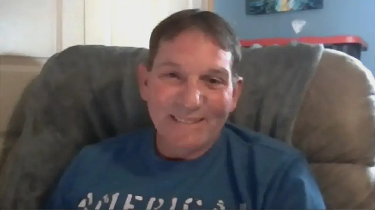 Kenneth Card speaks from a chair in a Fox News interview about his Texas Roadhouse steak complaint