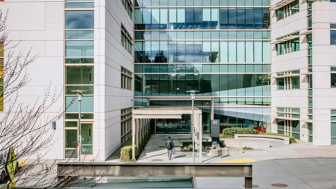 Microsoft Research's Redmond campus entrance, with a staff member walking toward the office building