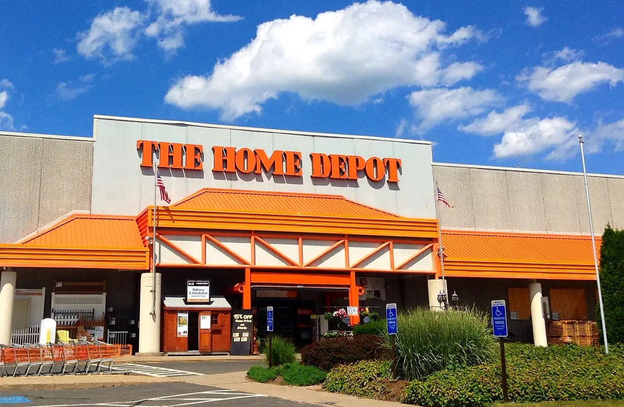 Exterior of a Home Depot store with its orange sign and entrance canopy under a blue sky