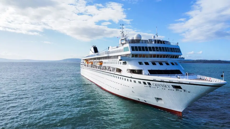 The Villa Vie Odyssey residential cruise ship sails on open water.